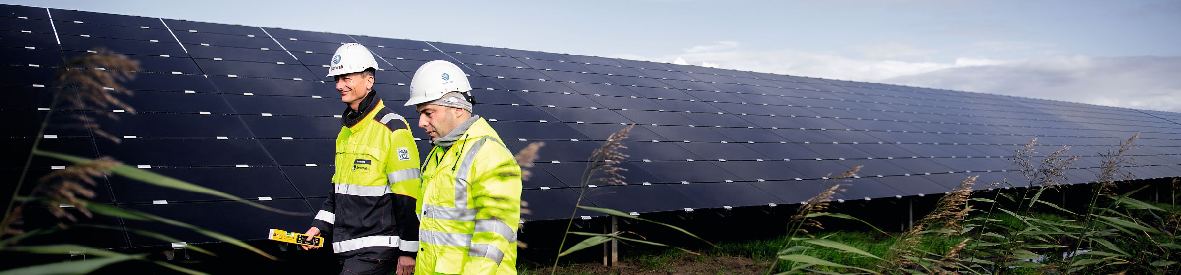 Men walking in solar park