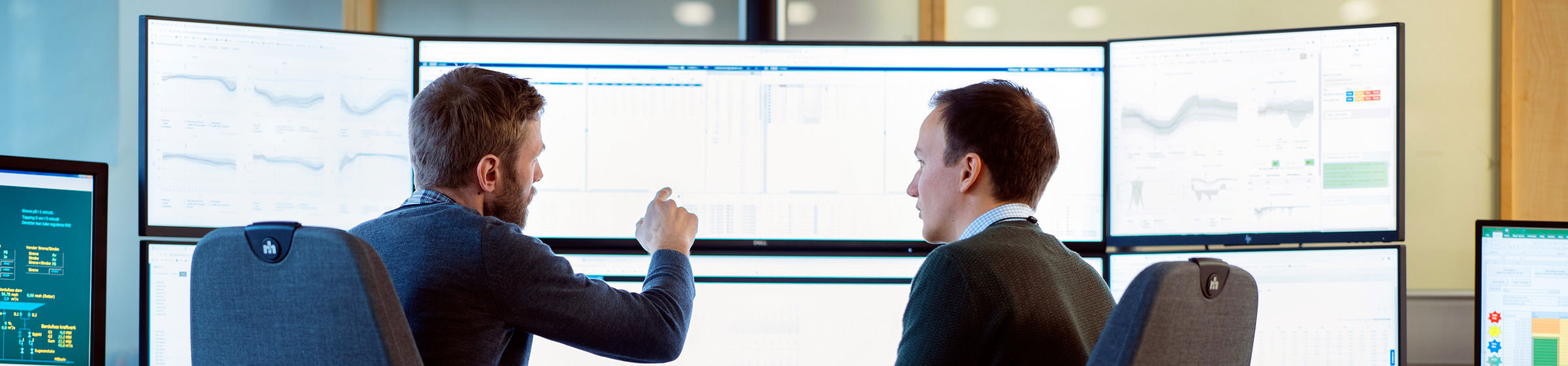 Two men discussing at computer screens